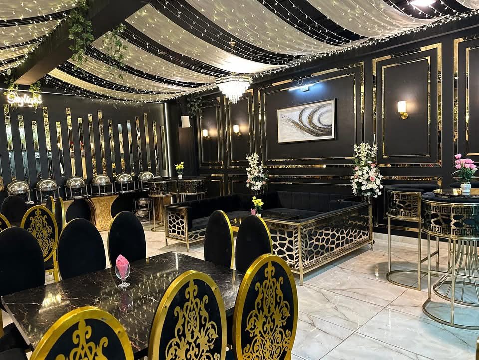 The hall set for guests with floral centrepieces and gold detailing