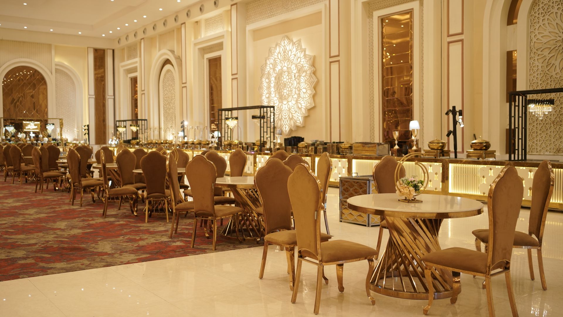 Opulent banquet hall with gold seating and luxurious decor